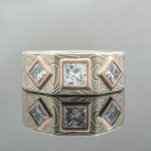 Mokume Gane Ring or Wedding Band in Wave Pattern w/ Moissanite Diamonds and Red Gold Bezel Settings Mokume Gane Ring or mens Wedding Band matching wedding bands custom bespoke 14K white gold yellow gold two tone two toned square ring square shaped ring hexagon mens engagement ring unique bezel set square diamond diamonds woodgrain Pattern silver palladium alternative metal nature inspired rustic artisan topographical earthy style unique handmade matching wedding bands mens womens custom wedding band