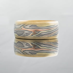 Mokume gane ring mens wedding band Feathered mokume gane design in yellow gold, oxidized silver, palladium and red gold. With rails Contemporary bespoke mixed metal tricolor rose gold topographical woodgrain pattern nature inspired artisan made handmade 
