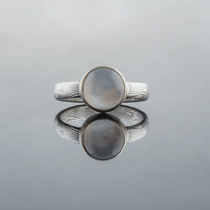 Mokume gane engagement ring with bezel set moonstone bezel setting. 14K white gold palladium sterling silver Beautiful artisan made handmade unique womens engagement ring light blue stone