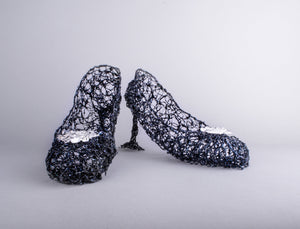 Blue wire shoe sculptures with glass cluster attached to toe
