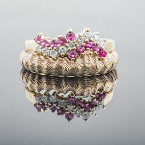 custom made mokume wedding ring contoured around a sapphire engagement ring