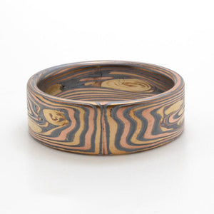 mokume gane linear patterned ring, Arn krebs' vortex pattern, in metal combination of red gold, yellow gold and oxidized silver