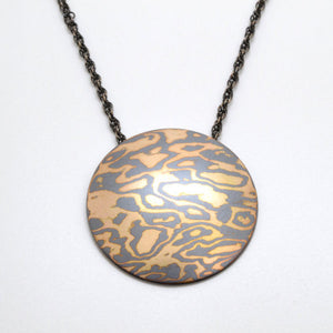 mokume gane disc pendant made in woodgrain pattern