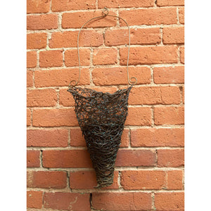 Large dark patina black thick copper wire woven into a cone shaped basket hanging from a curled wire ends, home decor, planter, vase, basket