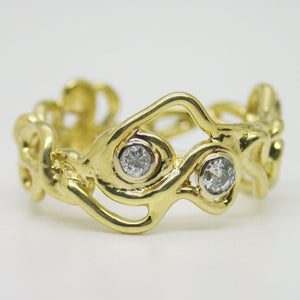 Elegant, organic, alternative, and timeless. This ring was made as a combined engagement and wedding band and features conflict free diamonds and responsibly mined 14kt yellow gold. Choose this design or customize yours with us.