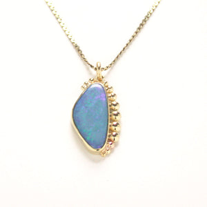 18kt yellow gold has been hand crafted to create a pebbled effect surrounding this lovely Australian Opal with lots of fire.  Paired on a 16" yellow gold chain   