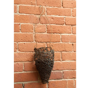 Small dark patina black thick copper wire woven into a cone shaped basket hanging from a curled wire ends, home decor, planter, vase, basket